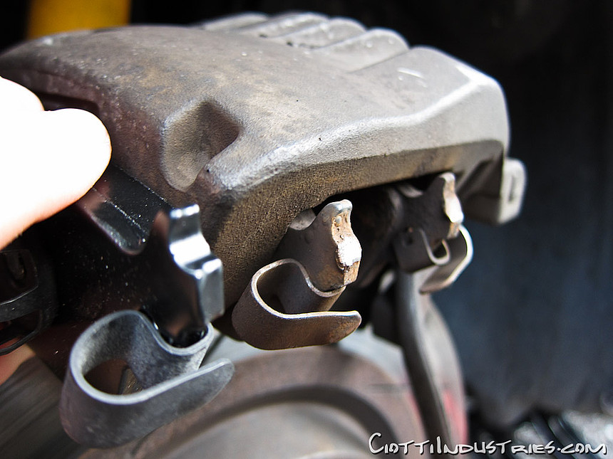 Front brake pad backing plate failed, caliper bracket at fault